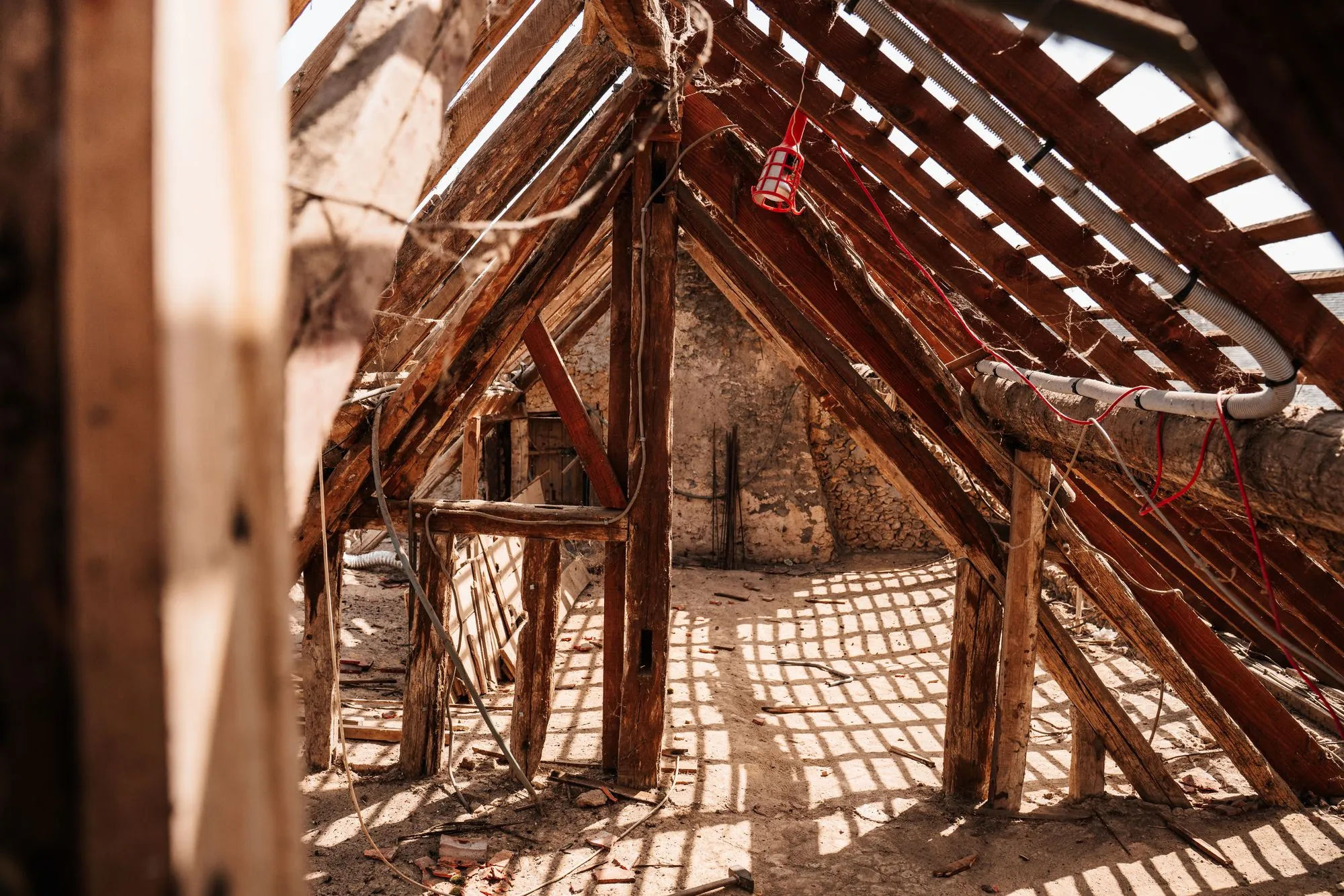 Rafters and the underside of the deck seen from inside an unfinished attic